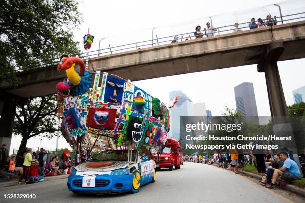 Art car enthusiast watch the 28th Annual Art Car Parade from a bridge near downtown Houston, Saturday, April 11, 2015.
