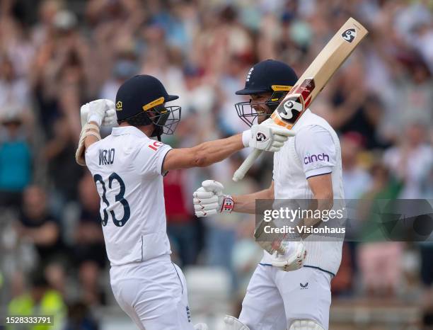 Chris Woakes of England celebrates with Mark Wood after hitting the winning runs to win the LV= Insurance Ashes 3rd Test Match between England and...