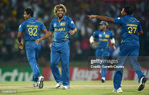 Lasith Malinga of Sri Lanka celebrates with Nuwan Kulasekara and Mahela Jayawardene after winning the super over and beating New Zealand during the...