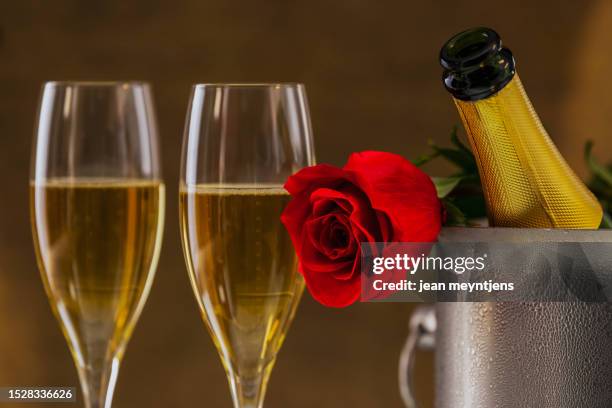 close up of red rose with champagne bottle and glasses - champange bottle and valentines day stock pictures, royalty-free photos & images