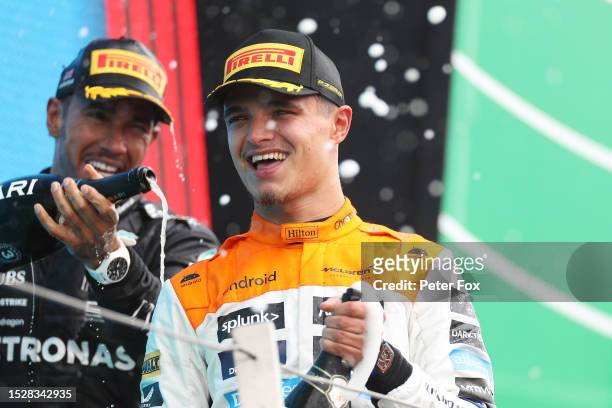Second placed Lando Norris of Great Britain and McLaren celebrates with third placed Lewis Hamilton of Great Britain and Mercedes on the podium...