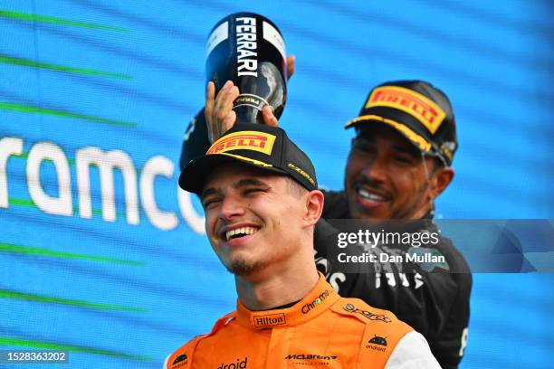 Second placed Lando Norris of Great Britain and McLaren celebrates with third placed Lewis Hamilton of Great Britain and Mercedes on the podium...