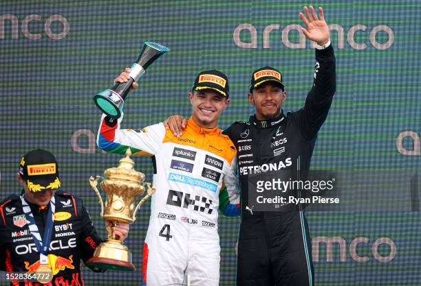 Second placed of Great Britain and McLaren and and third placed Lewis Hamilton of Great Britain and Mercedes celebrate on the podium during the F1...