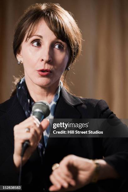 caucasian businesswoman speaking into microphone - political uncertainty stock pictures, royalty-free photos & images