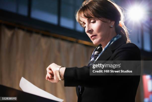 caucasian businesswoman checking the time - early stage stock pictures, royalty-free photos & images