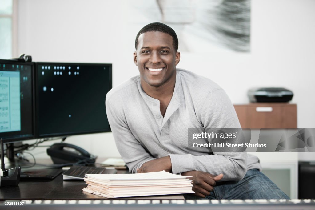 Black man sitting with paperwork