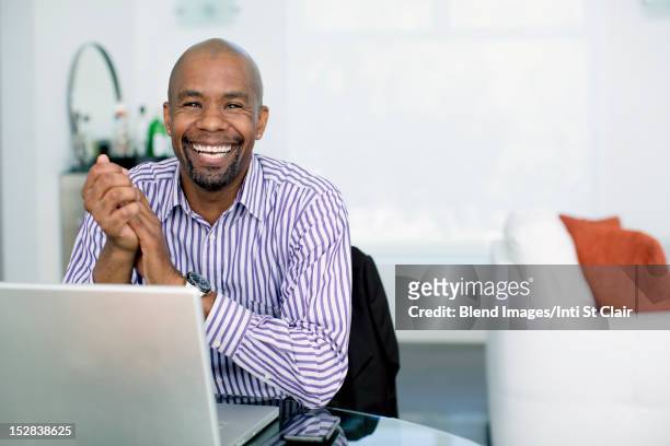 black businessman sitting with laptop - big smile stock pictures, royalty-free photos & images
