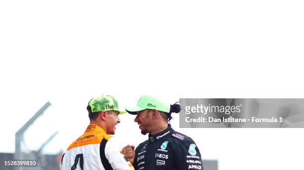Second placed Lando Norris of Great Britain and McLaren is congratulated by third placed Lewis Hamilton of Great Britain and Mercedes in parc ferme...