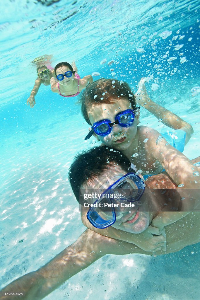 Family swimming underwater in sea