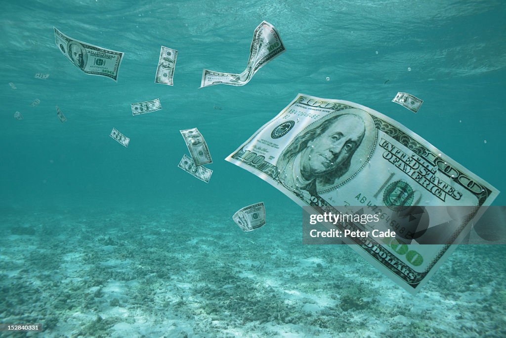 Money floating in ocean