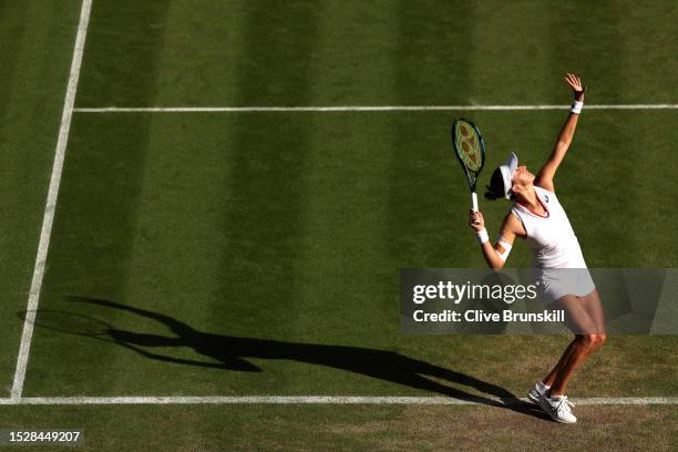 Belinda Bencic of Switzerland serves against Iga Swiatek of Poland in the Women's Singles fourth round match during day seven of The Championships...