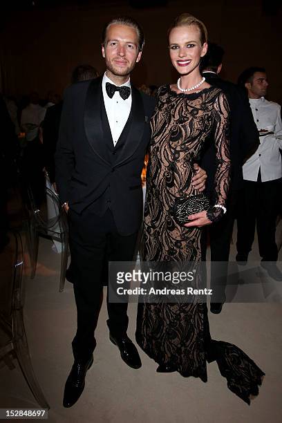 Michael Lillelund and Anne Vyalitsyna attend the amfAR Milano 2012 Cocktail Recepion during Milan Fashion Week at La Permanente on September 22, 2012...