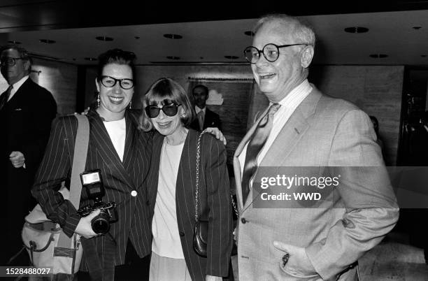 Guest, Joan Didion, and John Gregory Dunne attend an event at the Four Seasons, a restaurant n New York City, on April 14, 1993.