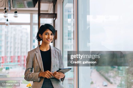 Young Businesswoman Posing by Window Young Businesswoman Posing by Window