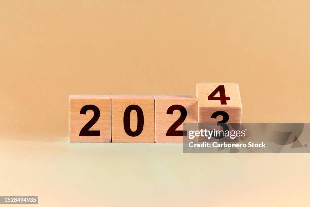 concept of the end of 2023 and the new beginning in 2024. change from 2023 to 2024 in wooden cubes. - start date stock pictures, royalty-free photos & images