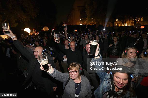 People toast Arthur as projections light up Senate House as part of Guinness celebrations for Arthur's Day on September 27, 2012 in London, England....