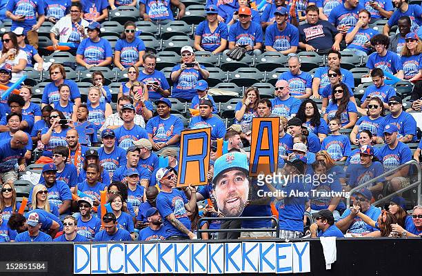 Fans hold signs in support of R.A. Dickey of the New York Mets getting his 20th win of the season against the Pittsburgh Pirates at Citi Field on...