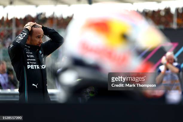 Third placed Lewis Hamilton of Great Britain and Mercedes looks on in parc ferme during the F1 Grand Prix of Great Britain at Silverstone Circuit on...