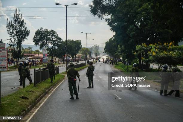 Anti-riot police take their position and attempt to disperse protesters who had barricaded the highway from Nairobi to Kisumu with rocks and burning...