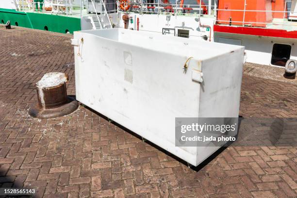rectangular white-colored plastic container stands on the quay of the port - yoghurt lid stock pictures, royalty-free photos & images