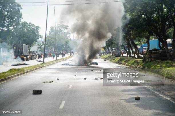 The main highway from Nairobi to Kisumu is blocked by burning tires and rocks during a countrywide protest against the government and high cost of...