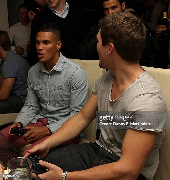 Boxer Anthony Ogogo and friend play computor games at the FIFA 13 launch party at The Mayfair Hotel on September 27, 2012 in London, England.