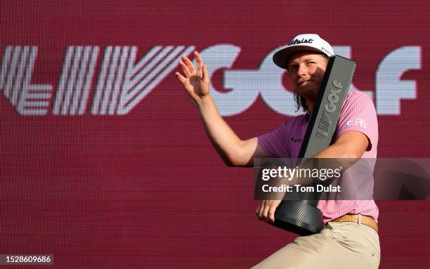 Cameron Smith of Australia celebrates with the trophy after his win on day three of LIV Golf - London at The Centurion Club on July 09, 2023 in St...