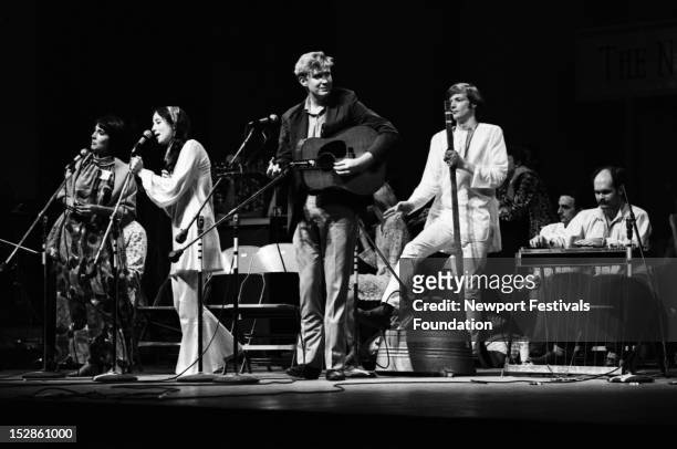 Folk musicians Mimi Farina, Maria Muldaur, Jim Rooney, Fritz Richmond, and Bill Keith perform in July, 1968 at the Newport Folk Festival in Newport,...