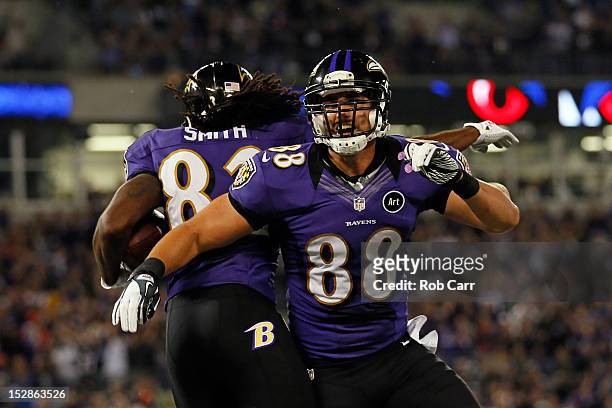 Wide receiver Torrey Smith of the Baltimore Ravens celebrates with his teammate tight end Dennis Pitta after scoring a touchdown in the second...