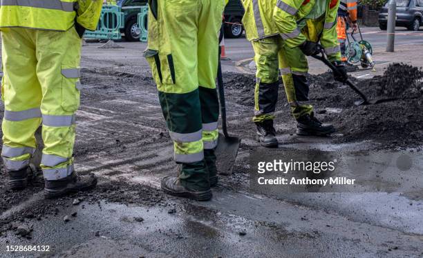 construction work men doing road works - road work stock pictures, royalty-free photos & images