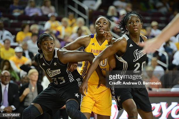 Nneka Ogwumike of the Los Angeles Sparks is boxed out by Sophia Young and Shameka Christon of the San Antonio Stars during Game 1 of the WNBA Western...