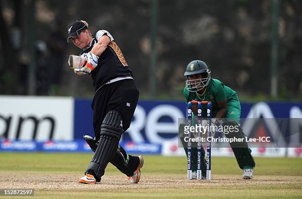 Sophie Devine of New Zealand smashes the ball for a six as Trisha Chetty of South Africa watches during the ICC Women's World Twenty20 Group B match...