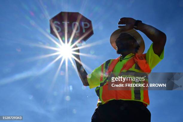 Traffic warden Rai Rogers mans his street corner during an 8-hour shift under the hot sun in Las Vegas, Nevada on July 12 where temperatures reached...