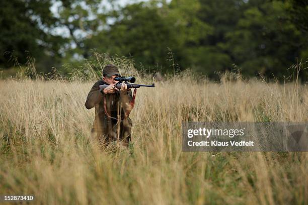 male hunter aiming with rifle - hunter stock pictures, royalty-free photos & images