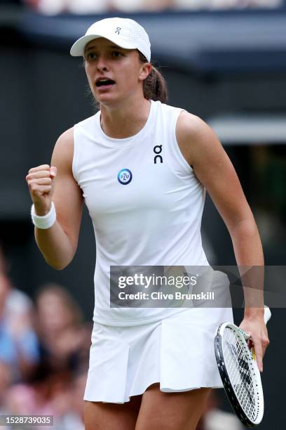 Iga Swiatek of Poland celebrates winning match point against Belinda Bencic of Switzerland in the Women's Singles fourth round match during day seven...