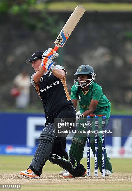 Sophie Devine of New Zealand smashes the ball towards the boundary as Trisha Chetty of South Africa watches during the ICC Women's World Twenty20...