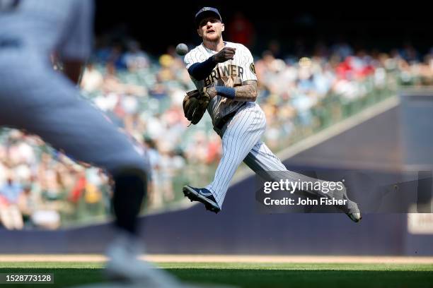 Brice Turang of the Milwaukee Brewers throws out a runner at first base in the seventh inning against the Cincinnati Reds at American Family Field on...