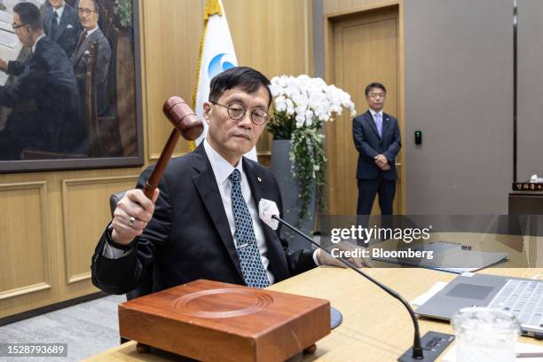 Rhee Chang-yong, governor of the Bank of Korea, hits a gavel as he starts a monetary policy meeting in Seoul, South Korea, on Thursday, July 13,...