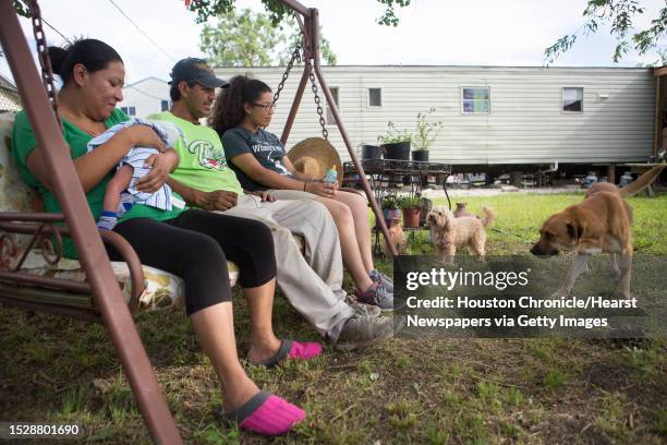 Leticia Sosa, her husband Jose Sosa and their daughter Erika Sosa enjoy an afternoon on their front yard accompanied by their dogs Simba and Lexi....