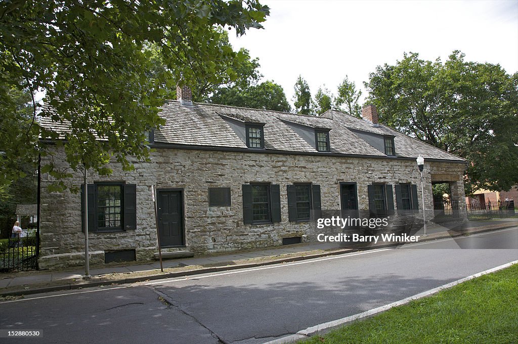 Old stone building with two doors and dormers.