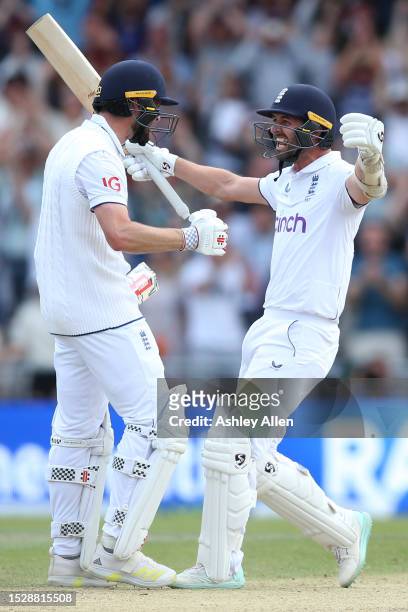 Mark Wood of England celebrates with teammate Chris Woakes as England win the LV= Insurance Ashes 3rd Test Match between England and Australia at...