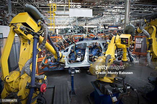 robots welding car body in car factory - robotic car stock pictures, royalty-free photos & images