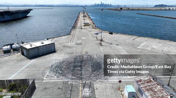 Tire marks from a recent sideshow are seen near the USS Hornet museum in Alameda, Calif., on Tuesday, June 27, 2023.