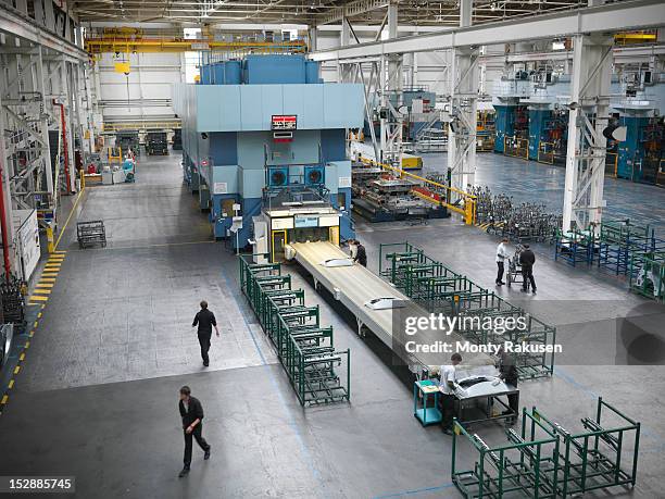 high angle view of car parts press in car factory - manufacturing machinery stockfoto's en -beelden