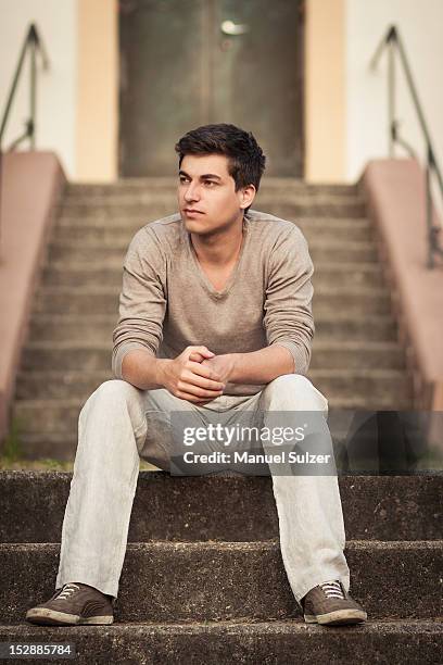 man sitting on front steps - sitting on front steps stock pictures, royalty-free photos & images