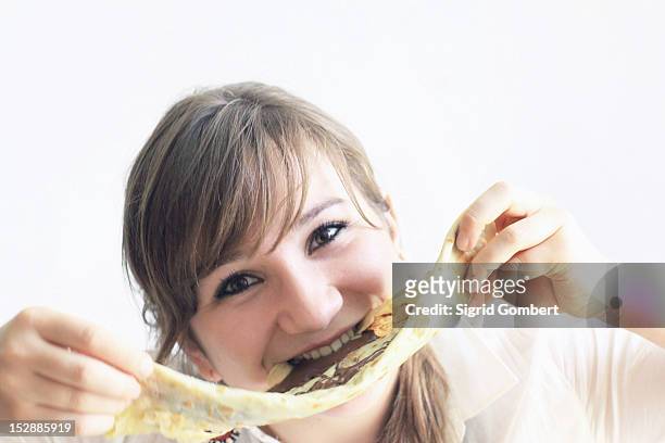 teenage girl playing with pancake - crêpe pancake photos et images de collection