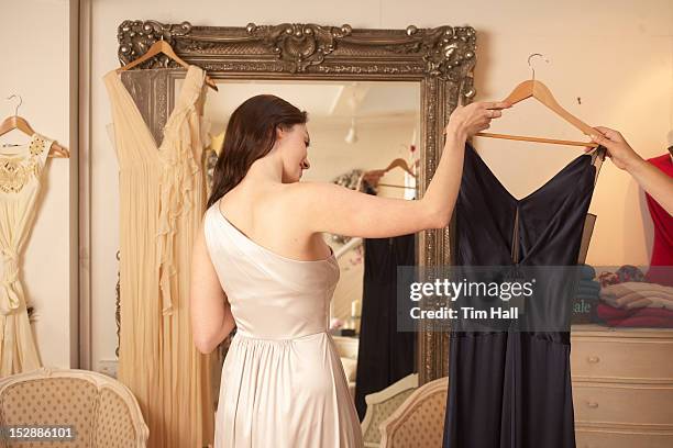 woman trying on dress in store - glamour bildbanksfoton och bilder