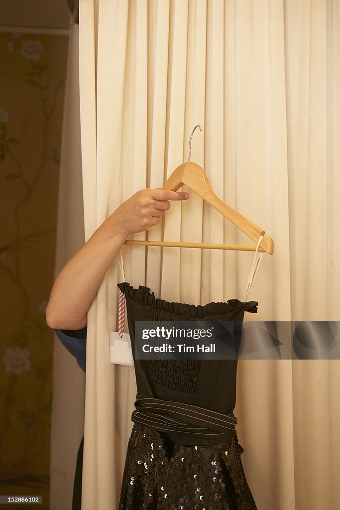 Woman trying on dress in store