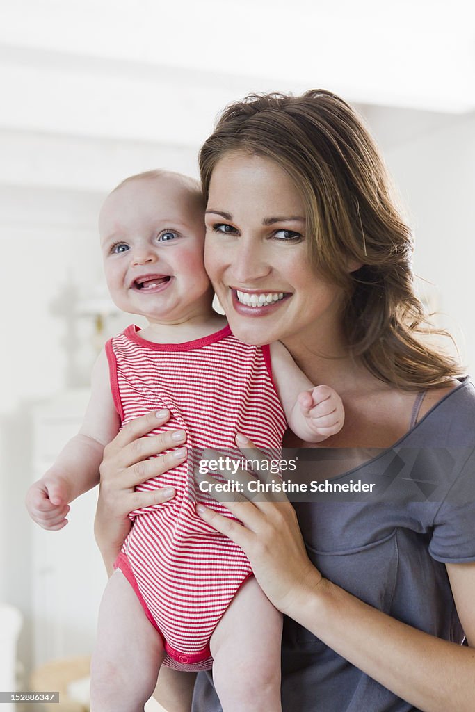 Smiling woman holding baby