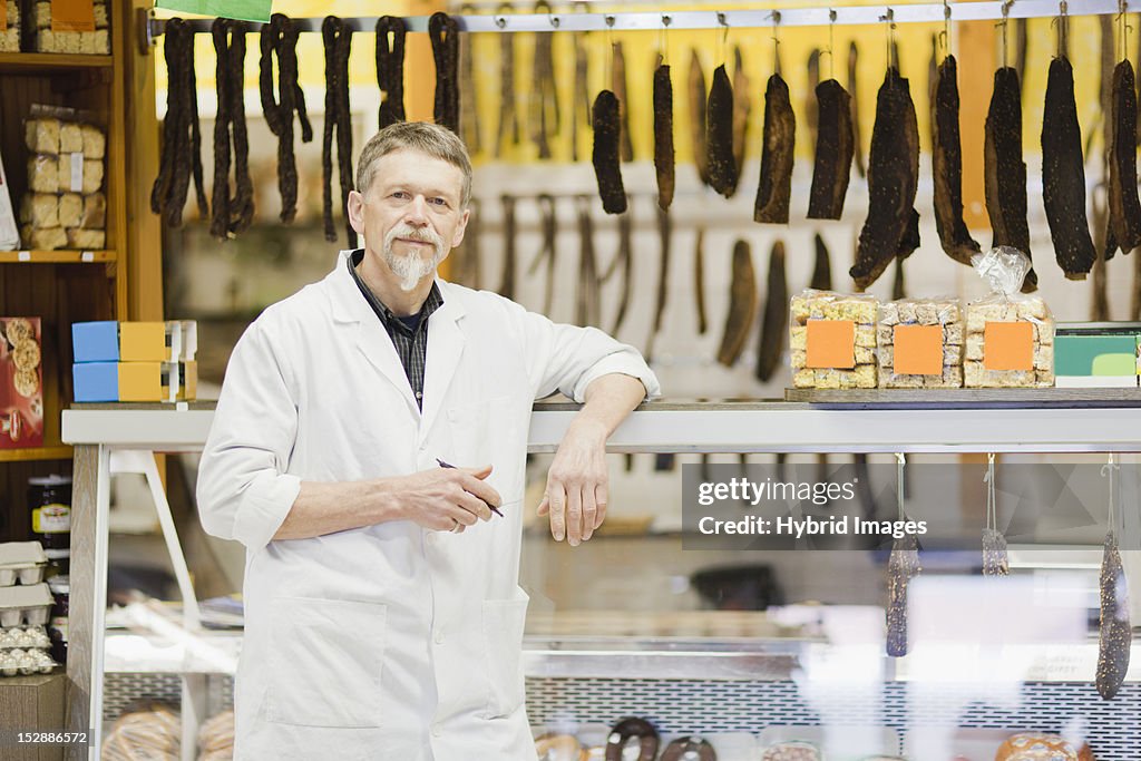 Butcher standing at meat counter